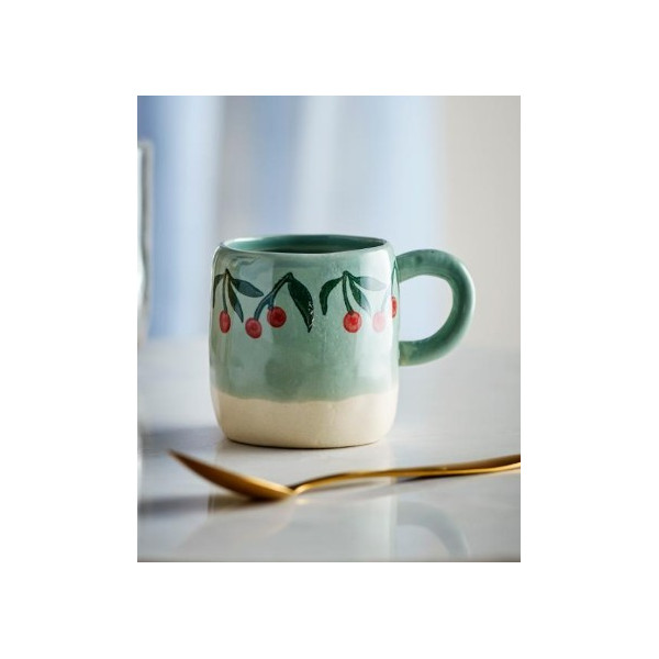 Tasse bleue avec cerise